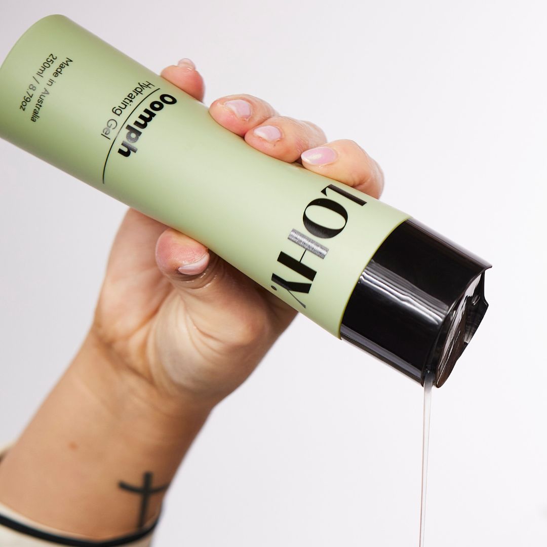 A hand squeezing a bottle of oomph hydrating gel