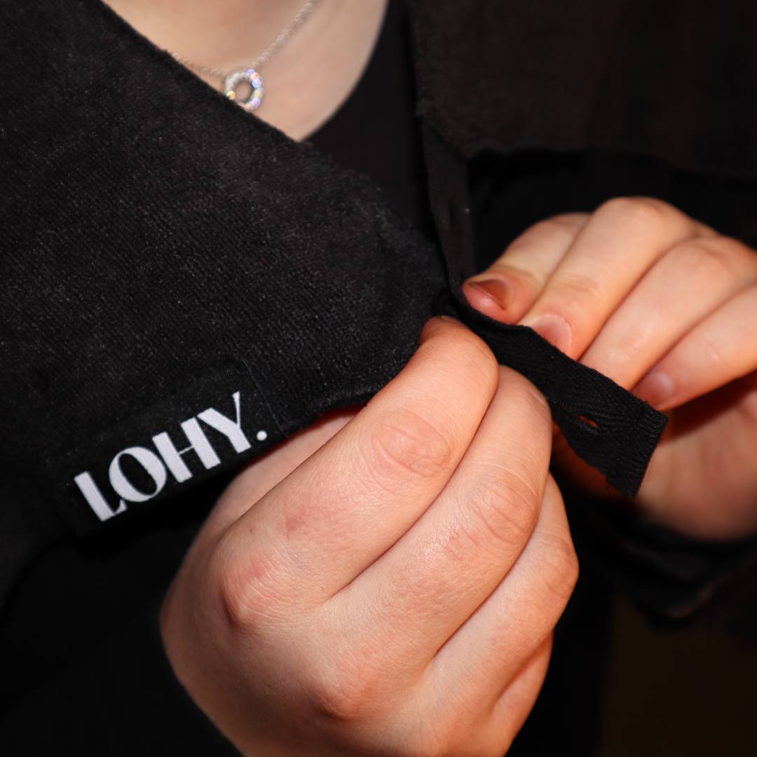 person buttoning up the cold shoulder guard