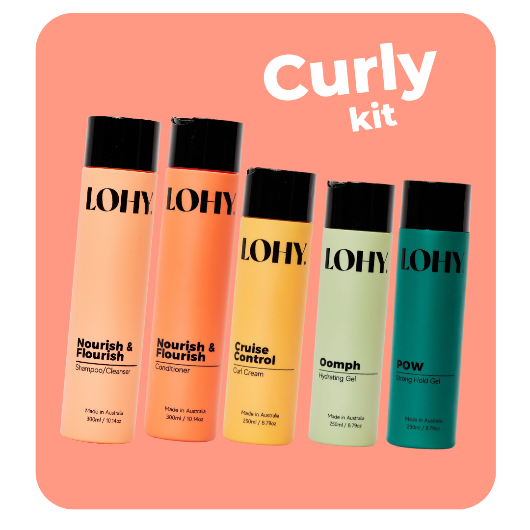 lohy. curly fine hair kit, which includes shampoo, conditioner, curl cream, hydrating gel, strong hold gel angled on a pastel red background