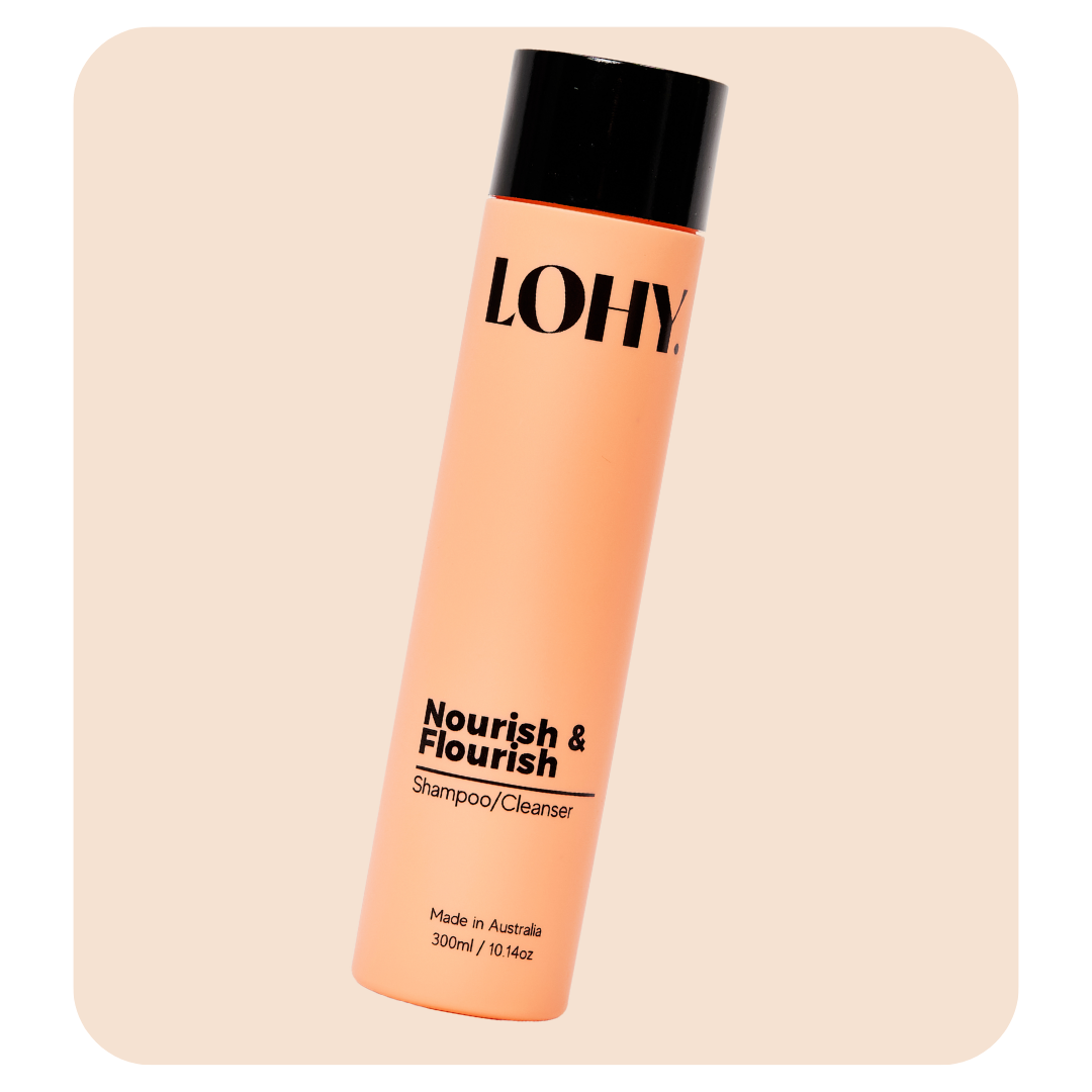 lohy nourish & flourish shampoo 300ml bottle angled on a pastel pink background