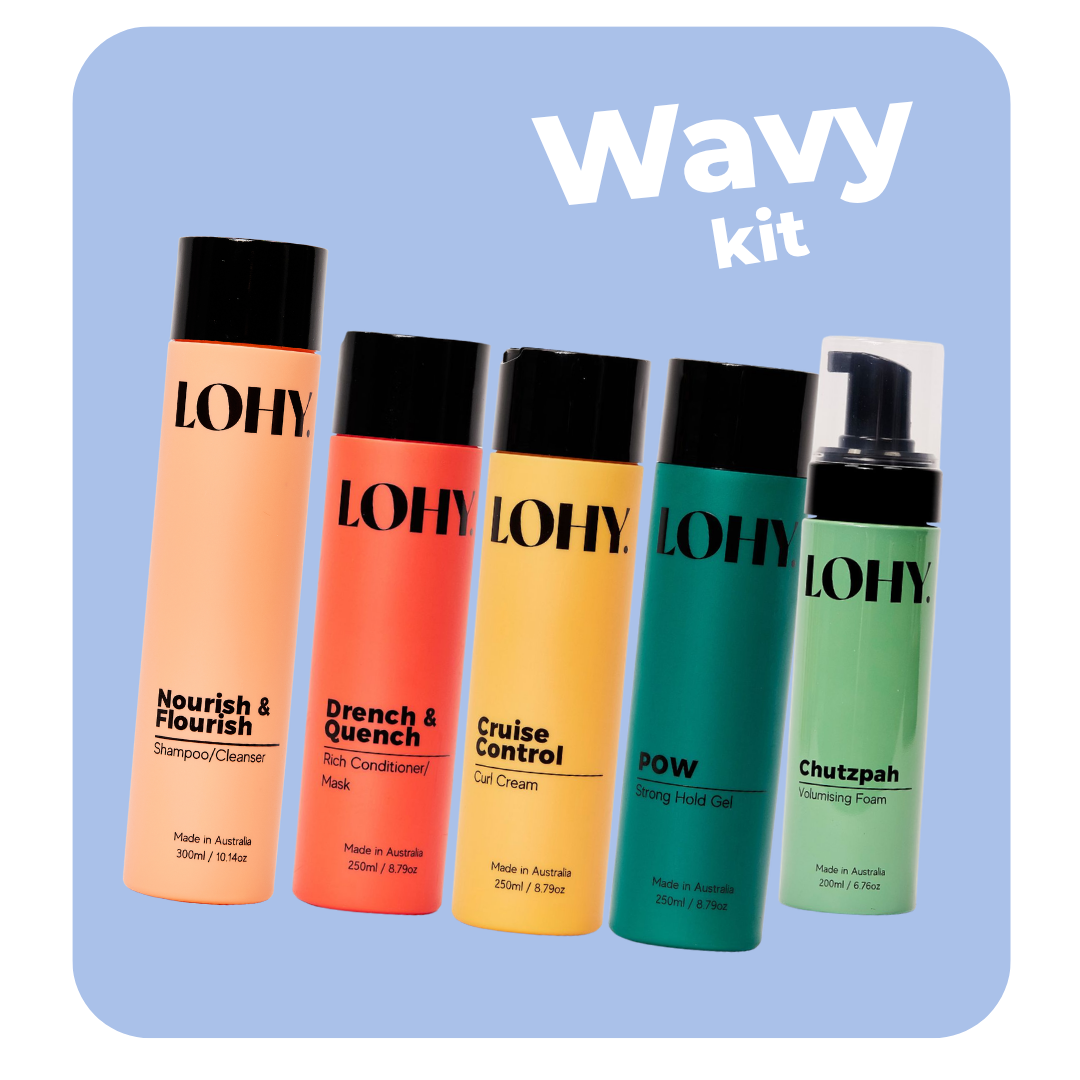 lohy. curly hair kit, which includes shampoo, rich conditioner, curl cream, strong hold gel and volumising foam bottles angled on a pastel blue background