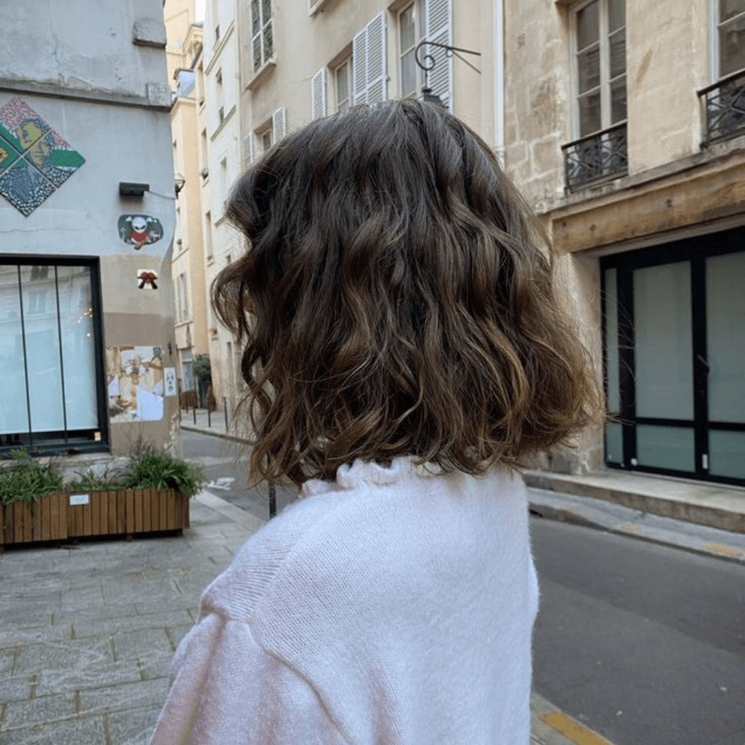 woman with short curly brunette hair