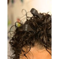 BRUNETTE CURLY HAIR WITH VOLUME COMBS IN HAIR