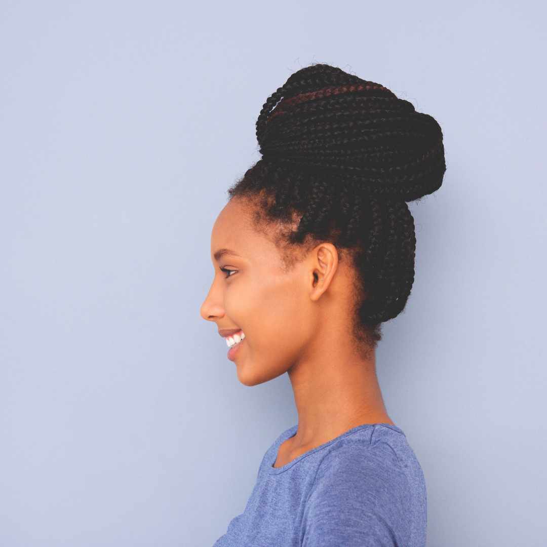 woman sideways, curly black hair, box braid bun