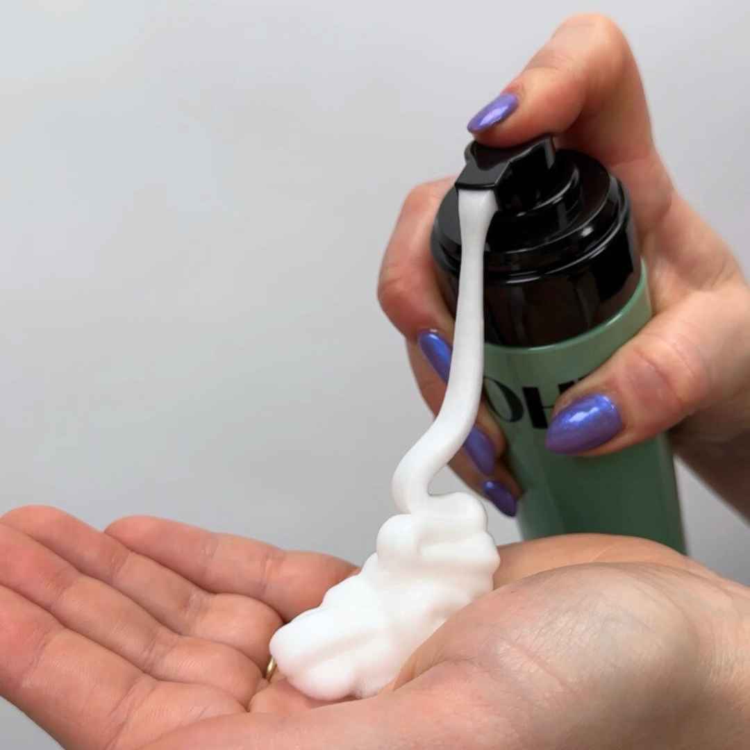 Volumizing mousse curly hair product being pumped into hand