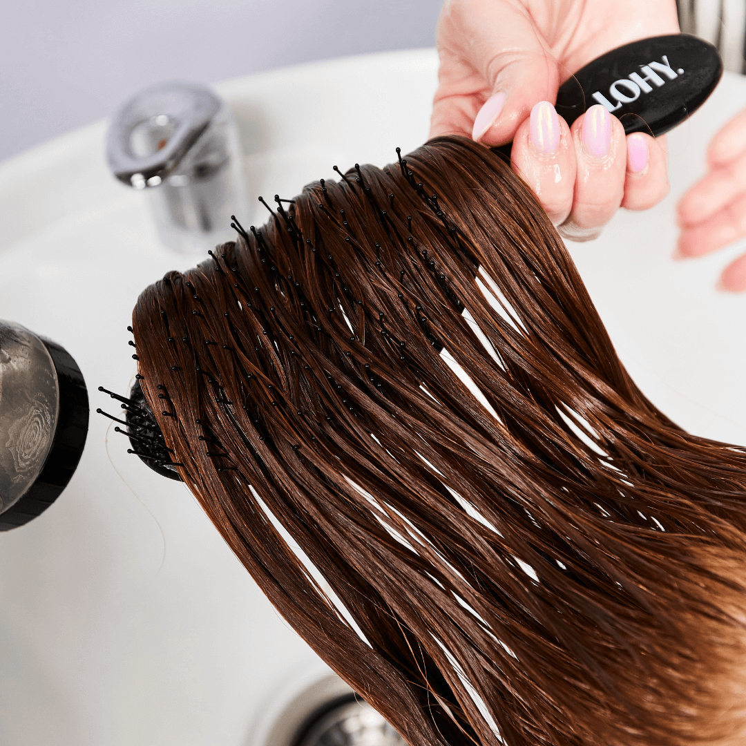 long red hair being brushed