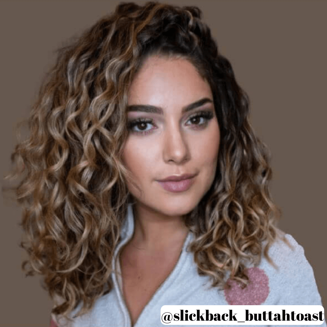 woman with shoulder length, curly, brunette hair