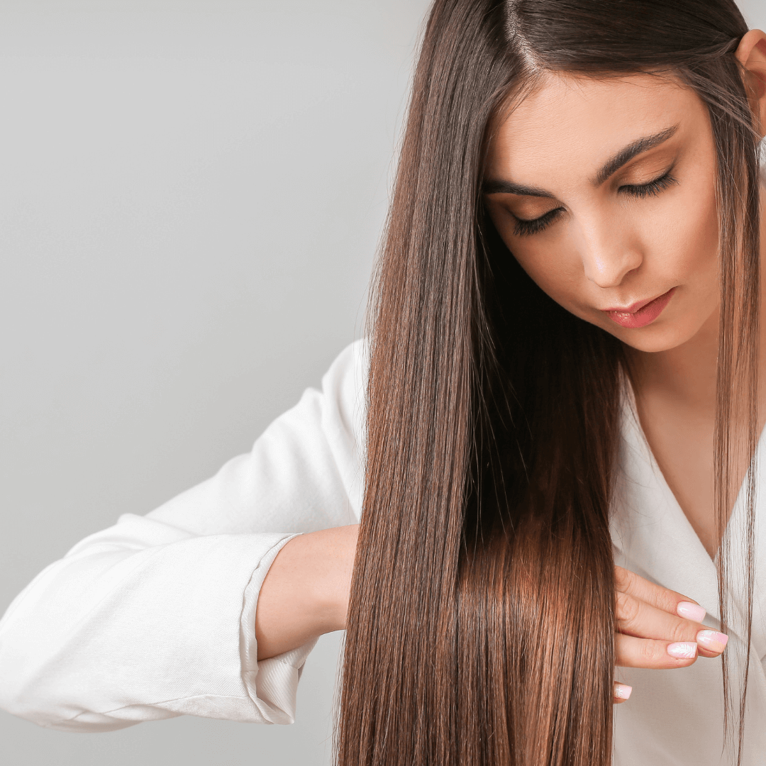 Lady holding long straight brunette hair