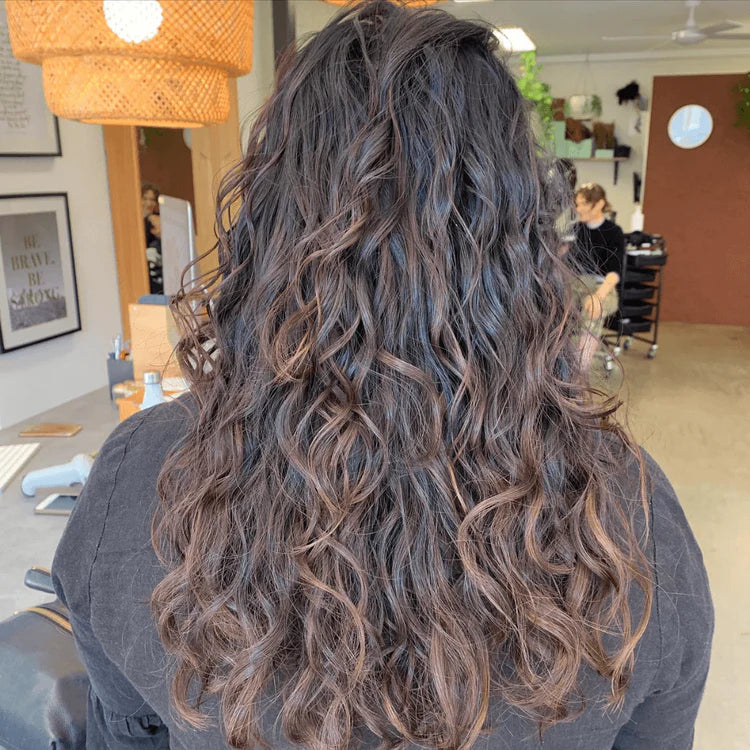 woman with long curly brunette hair