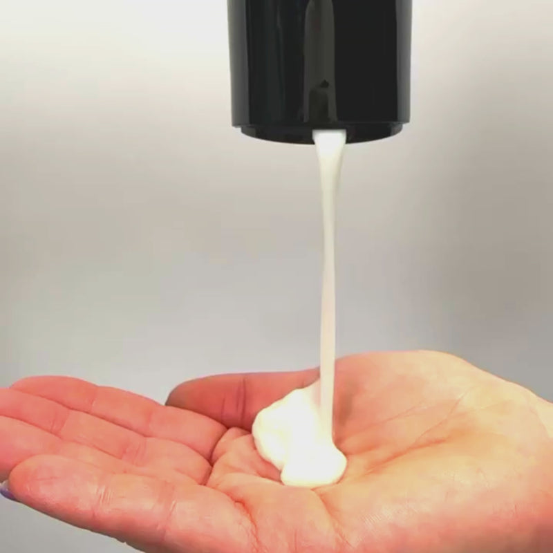 Curly hair conditioner being poured into hand