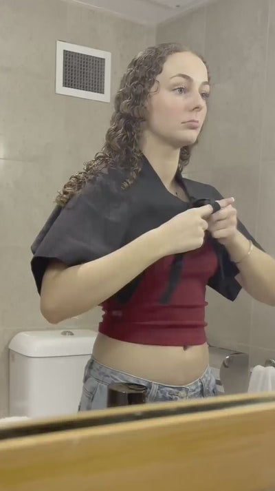 curly hair model, with brunette curly hair uses a LOHY. kit to define and style her hair