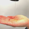 Strong hold gel being poured into hand