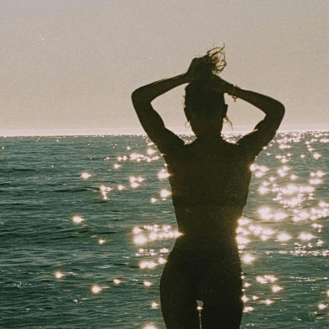 woman with brunette hair bun at water