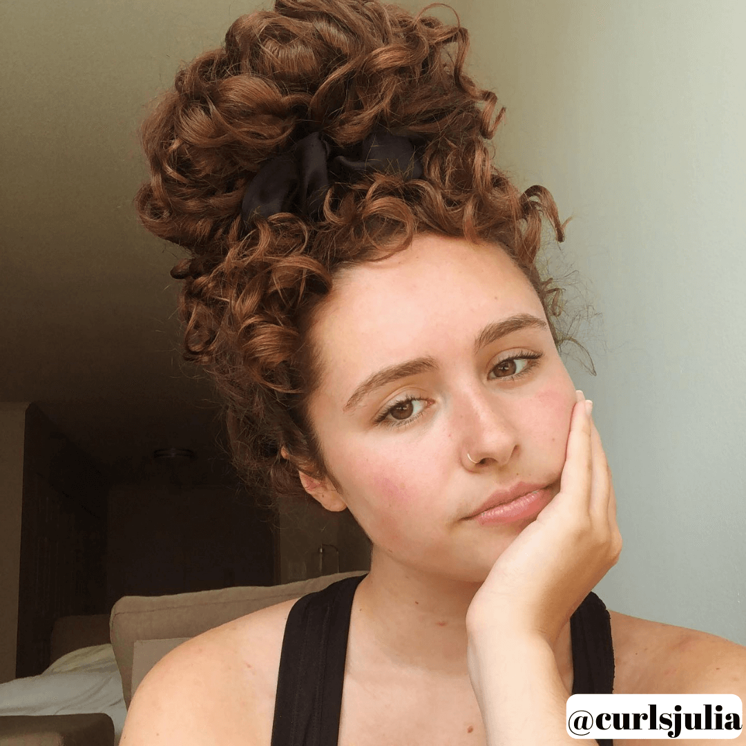 girl with long, curly, brunette, top bun