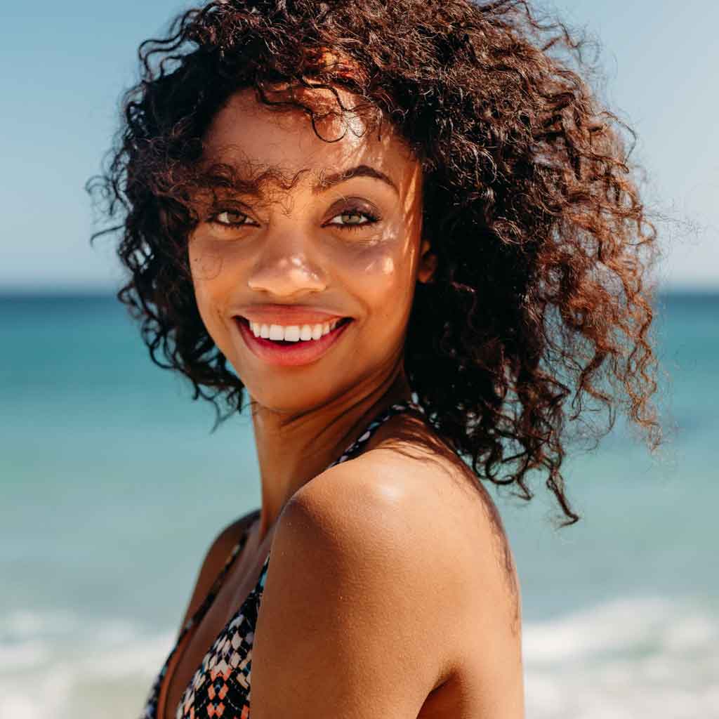 Girl at beach with type 3 curly hair