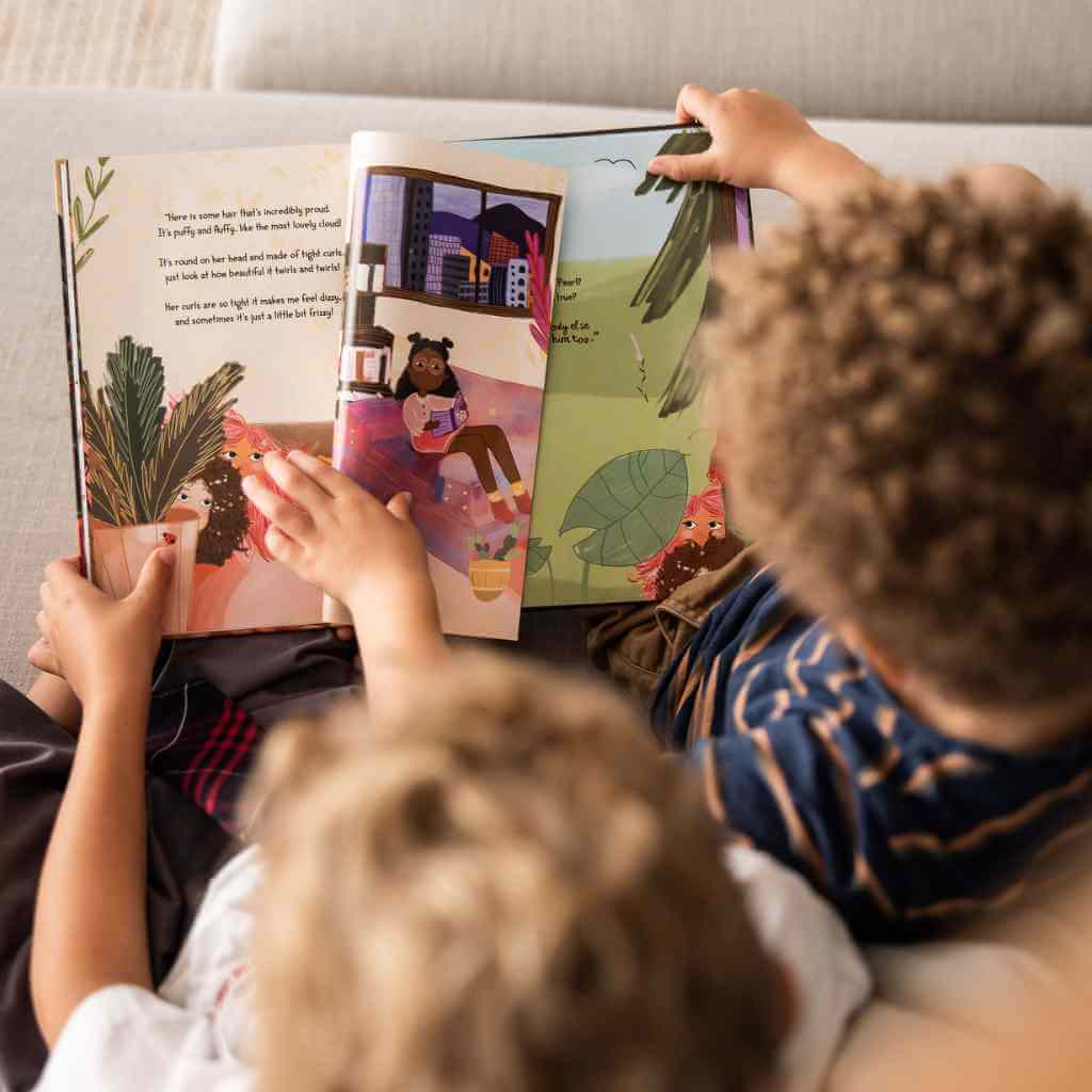 Children turning the pages of the Pearls curls book